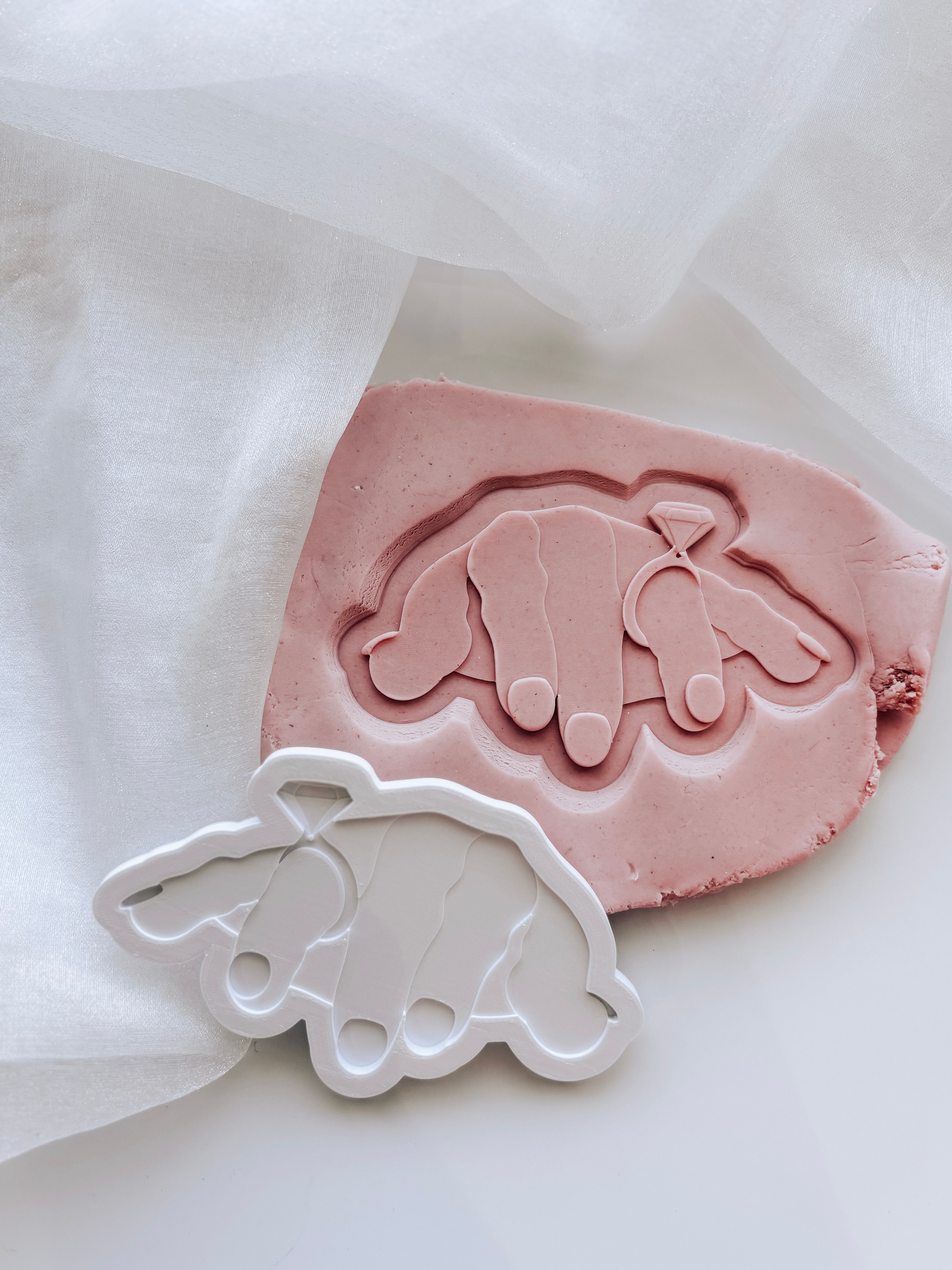 Female Ogre hand with engagement ring stamp and cutter