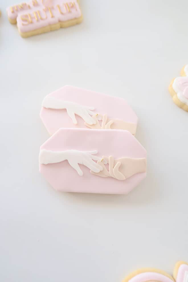 Hand placing ring on ring finger plate stamp and cutter