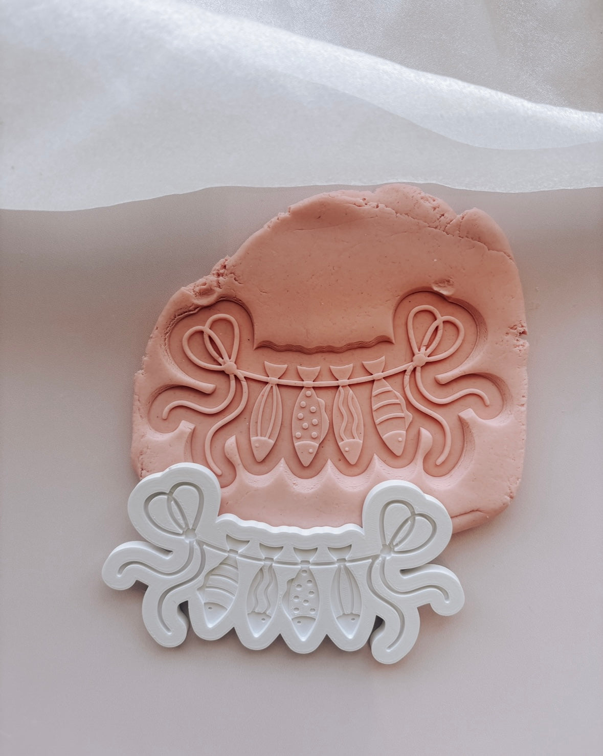 String line with hanging fish stamp and cutter