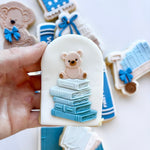 Stack of books with teddy on top stamp and cutter