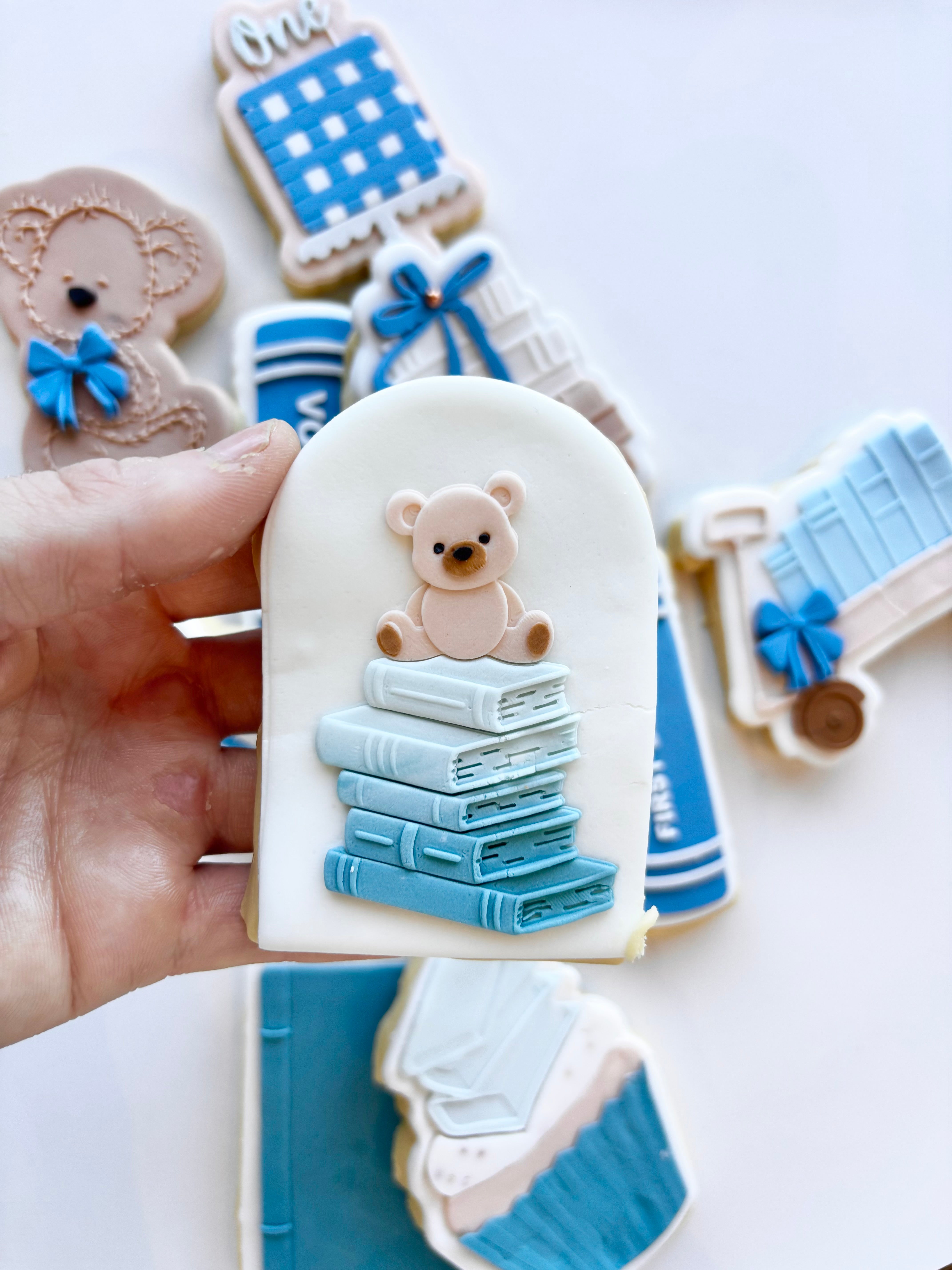 Stack of books with teddy on top stamp and cutter