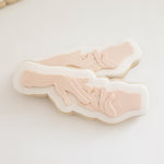 Hand placing ring on ring finger stamp and cutter