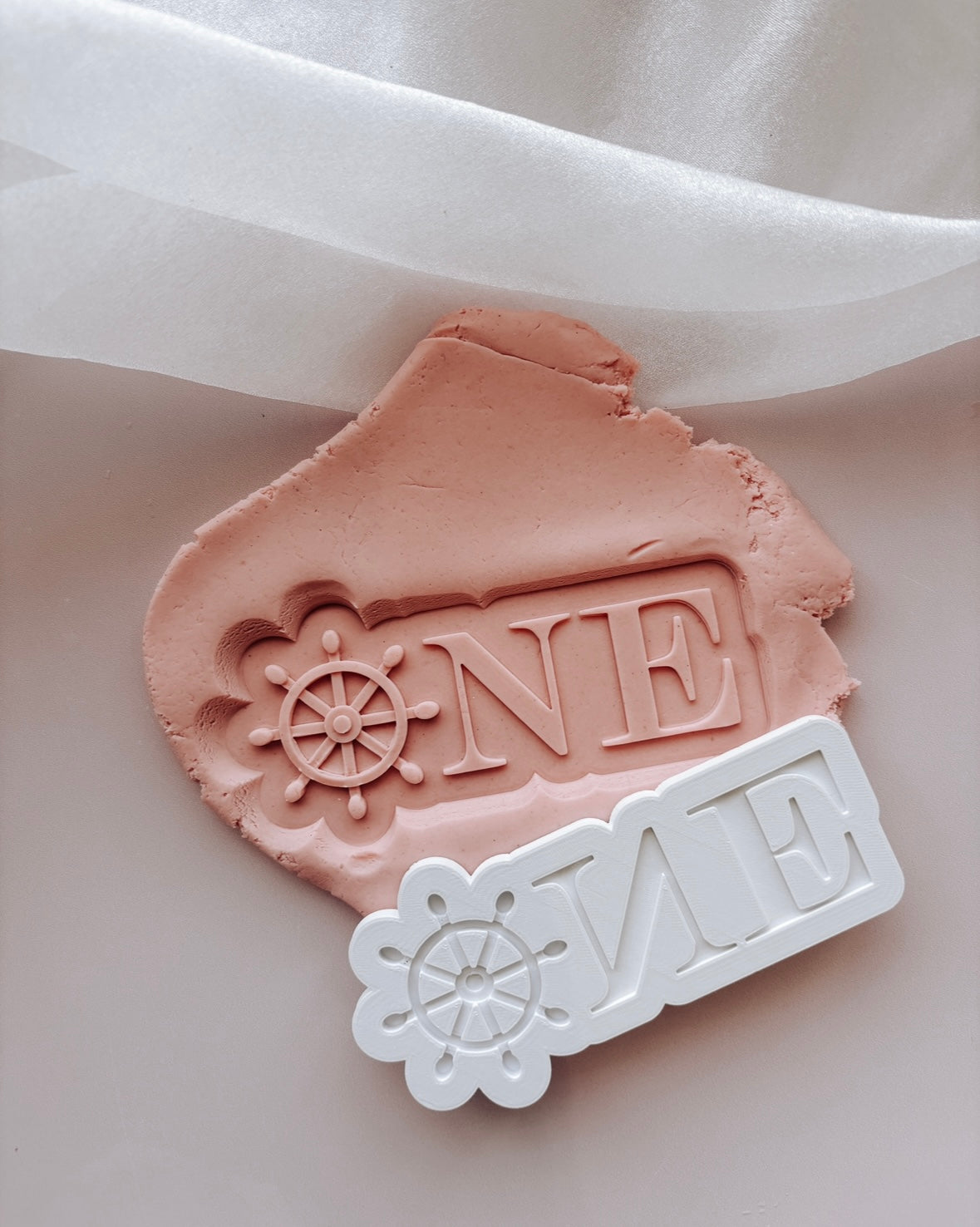 ONE with ship wheel “O” stamp and cutter