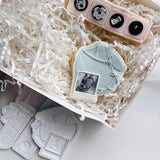 Long sleeved tied baby onesie with sonogram photo stamp and cutter