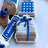 Stack of books with bow stamp and cutter