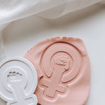 Female symbol with hand stamp and cutter
