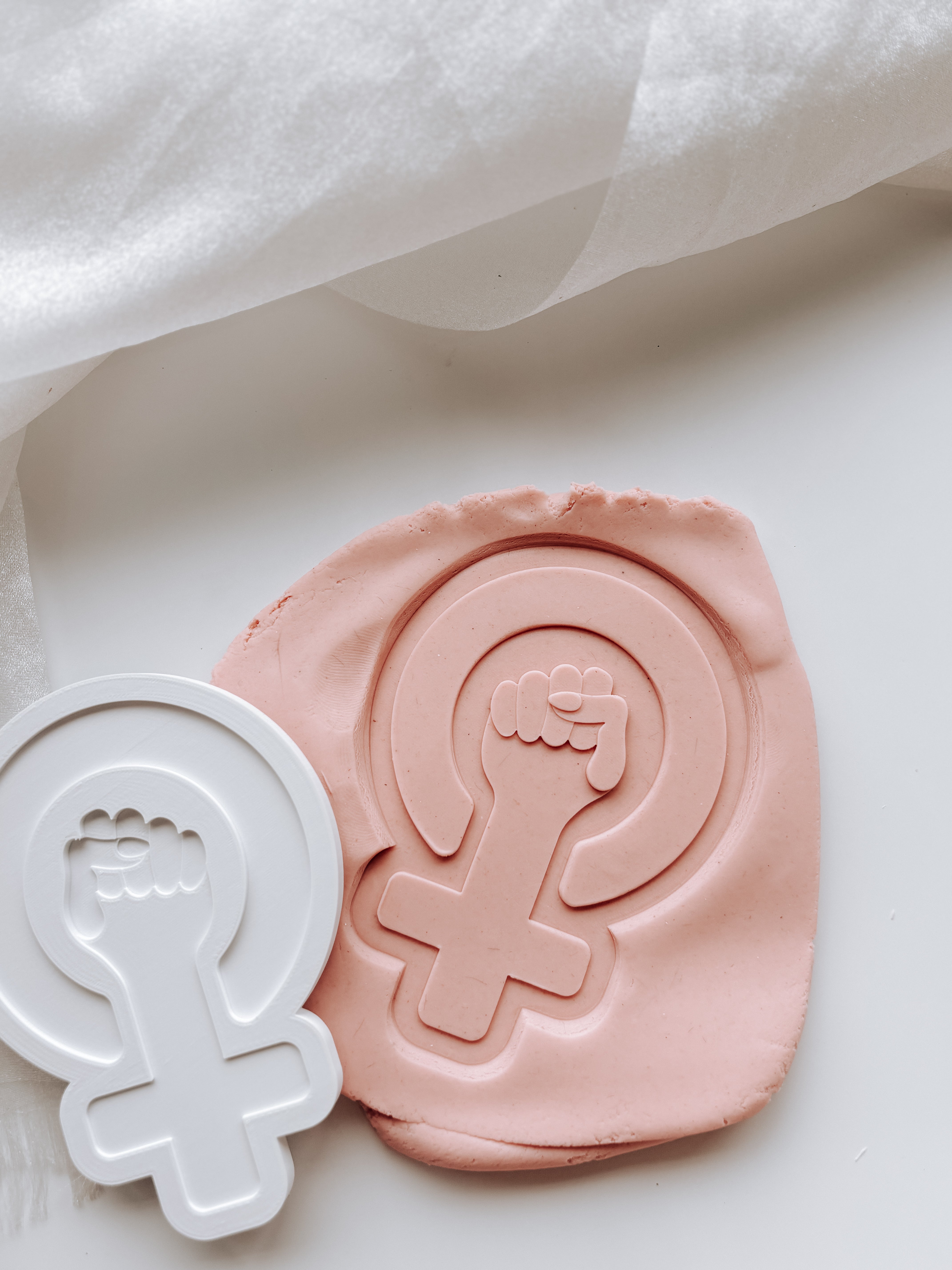 Female symbol with hand stamp and cutter