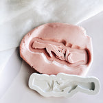 Hand placing ring on ring finger stamp and cutter