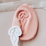 Layered string bow stamp and cutter