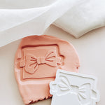 Bow tie on backer debosser and cutter