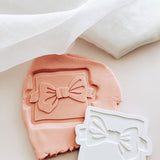 Bow tie on backer debosser and cutter