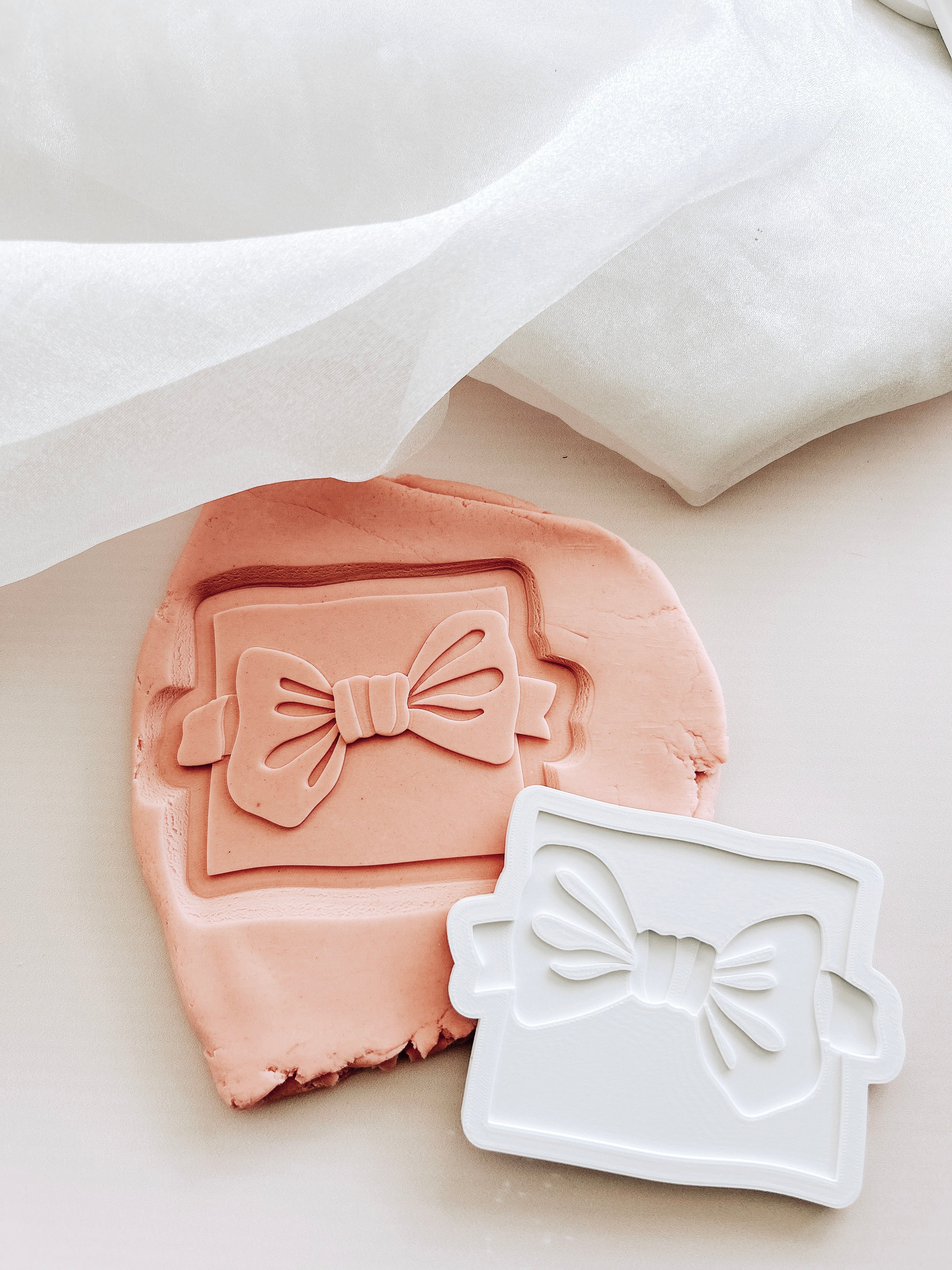 Bow tie on backer debosser and cutter