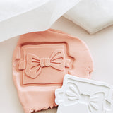 Bow tie on backer debosser and cutter