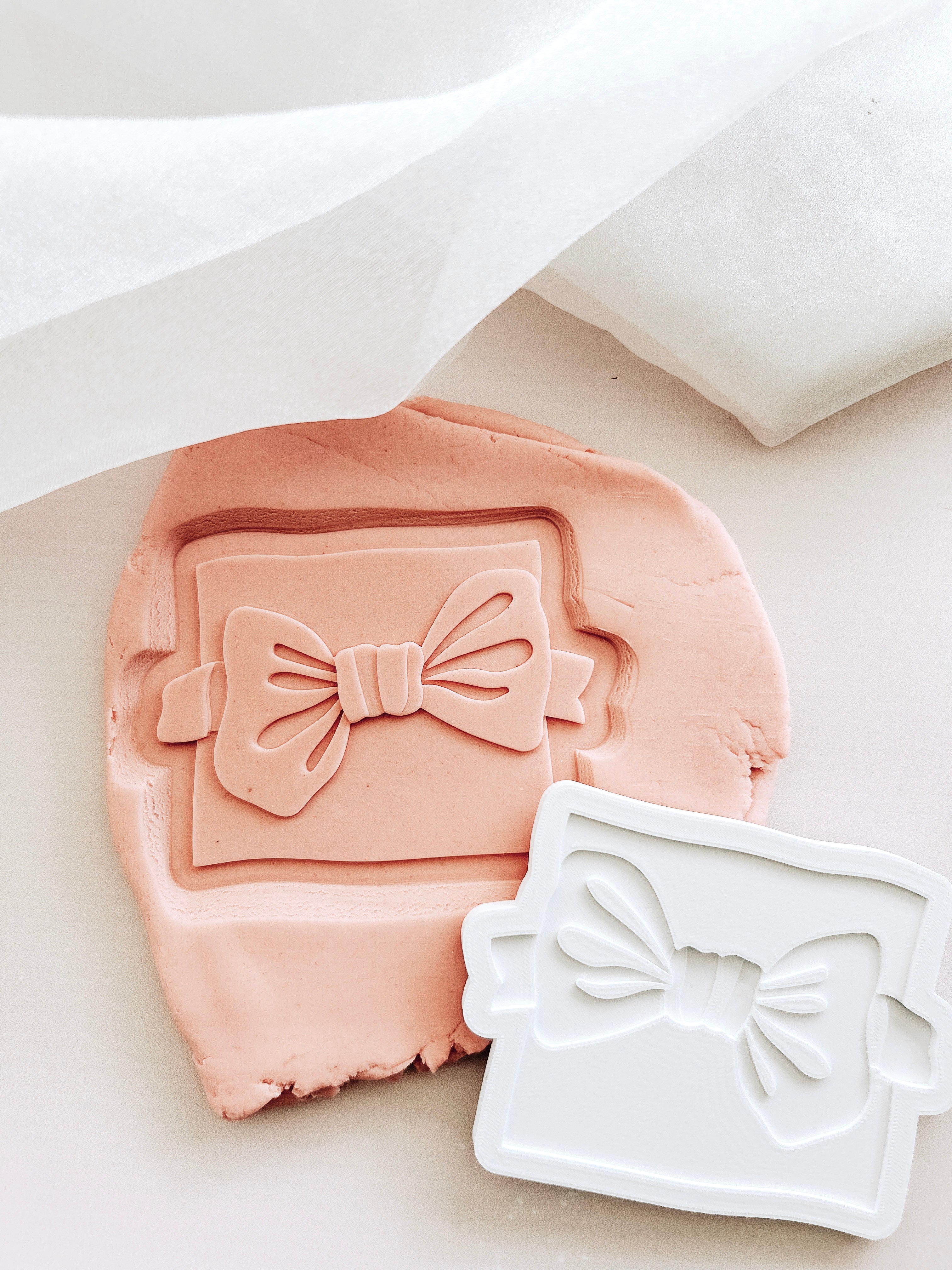 Bow tie on backer debosser and cutter