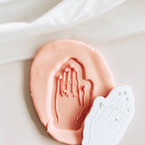 Hand with engagement ring debosser and cutter