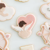 Cupid sitting near a heart shaped cloud stamp and cutter