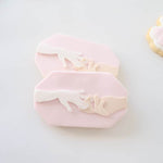 Hand placing ring on ring finger plate stamp and cutter