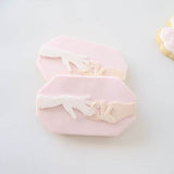 Hand placing ring on ring finger plate stamp and cutter