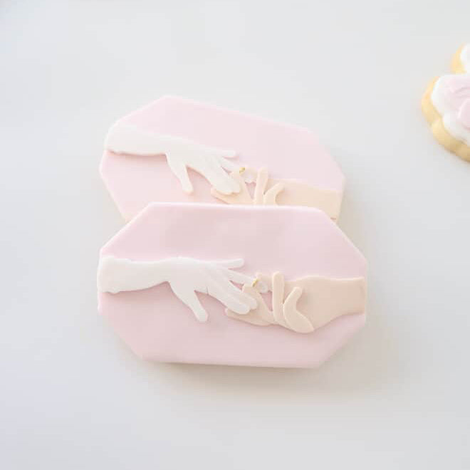 Hand placing ring on ring finger plate stamp and cutter