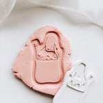 Engagement hand holding market grocery bag with mini embosser set stamp & cutter
