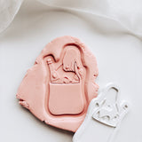 Engagement hand holding market grocery bag with mini embosser set stamp & cutter