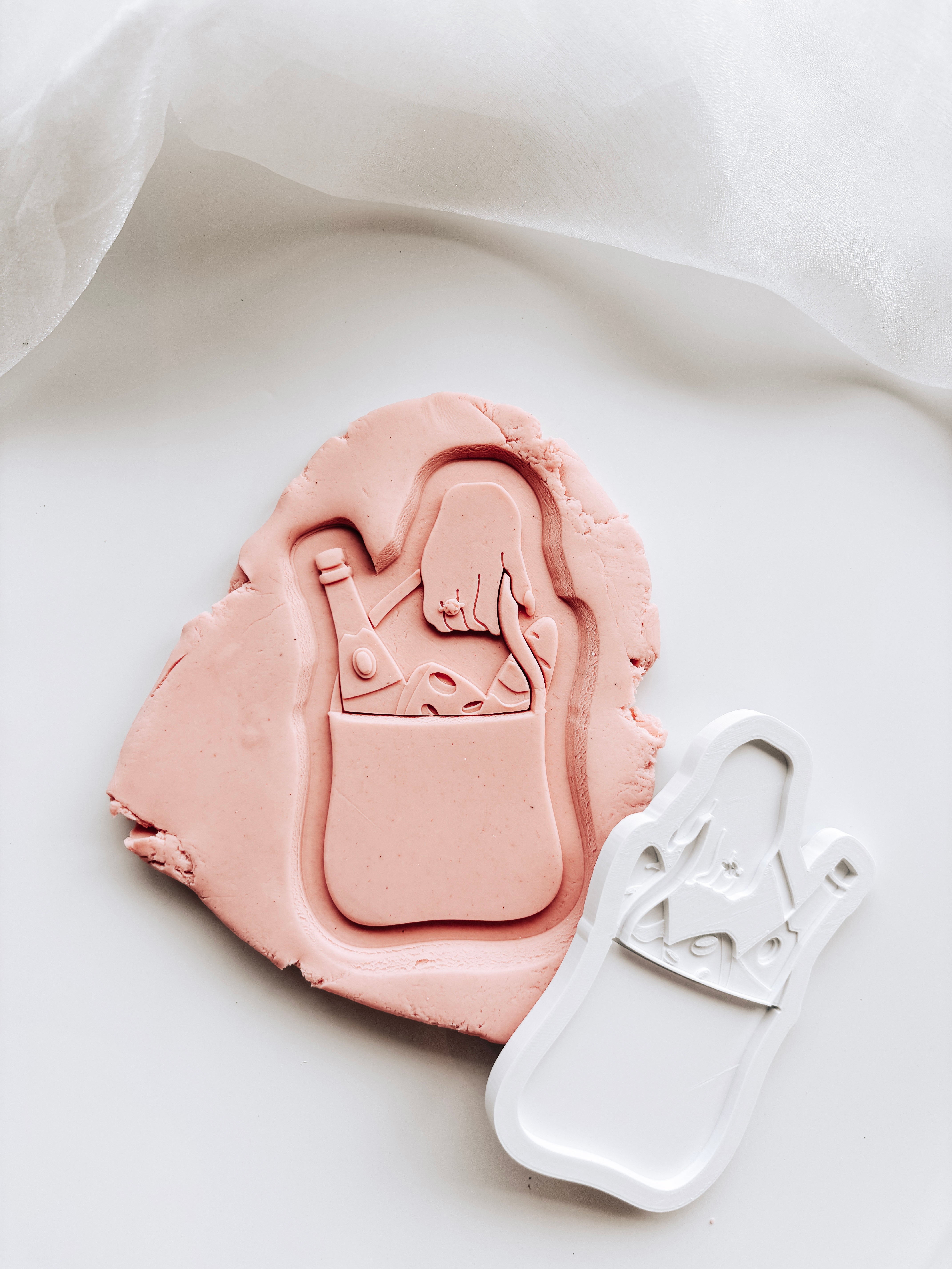 Engagement hand holding market grocery bag with mini embosser set stamp & cutter