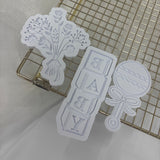 Odd Bunch- Baby’s breath, baby blocks & rattle