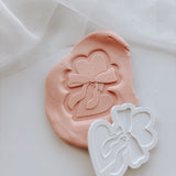 Heart shaped biscuit with bow stamp and cutter