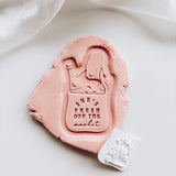 Engagement hand holding market grocery bag with mini embosser set stamp & cutter