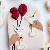Martini’s cheers in arch stamp and cutter