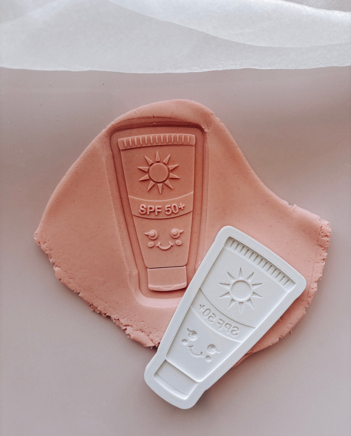 Sunscreen SPF 50 with smiley face Debosser stamp and cutter
