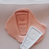 Sunscreen SPF 50 with smiley face Debosser stamp and cutter