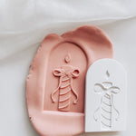 Stripes candle with devils tail bow in arch stamp and cutter