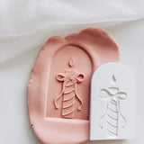 Stripes candle with devils tail bow in arch stamp and cutter