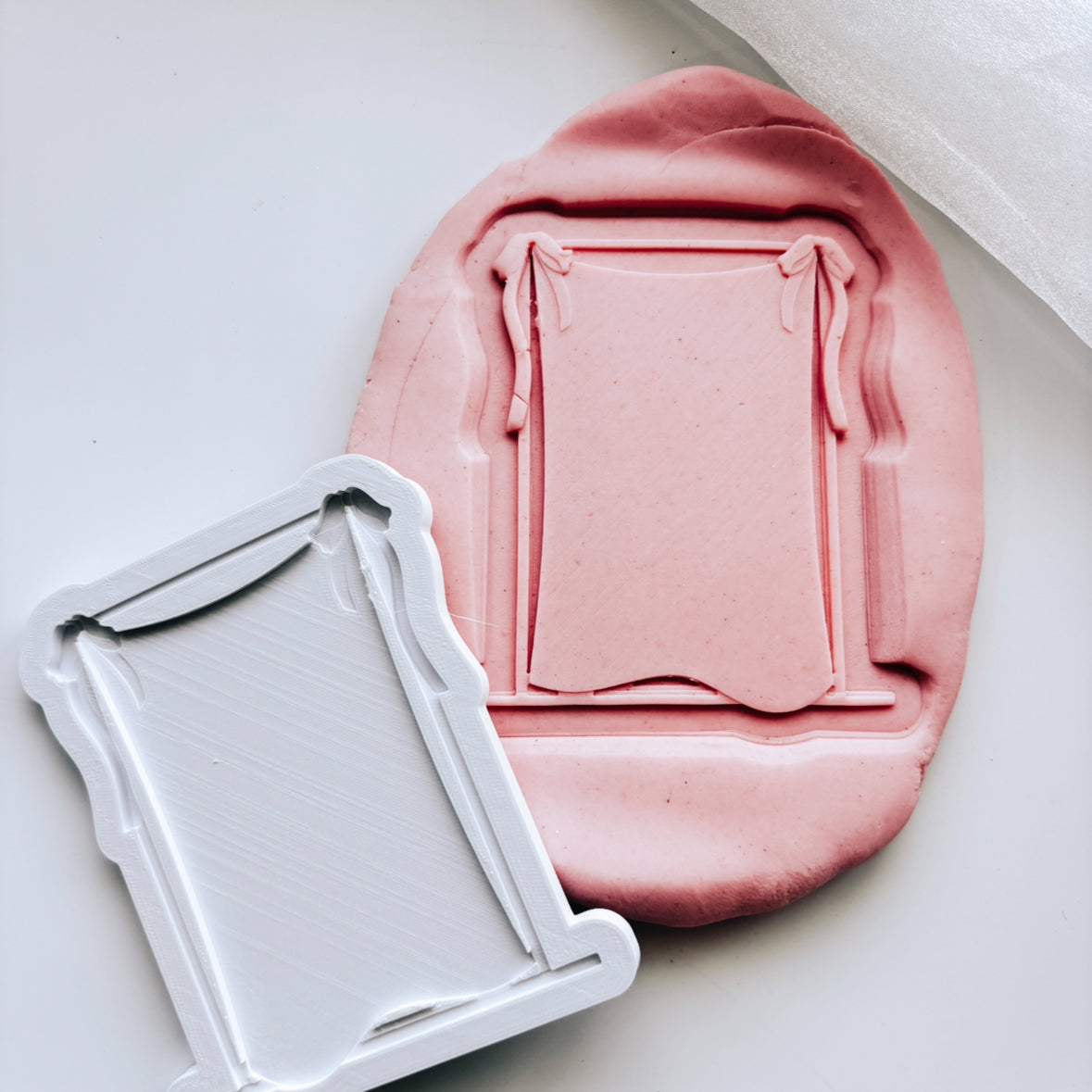 Blank draped material frame with bow on rectangle based stamp and cutter