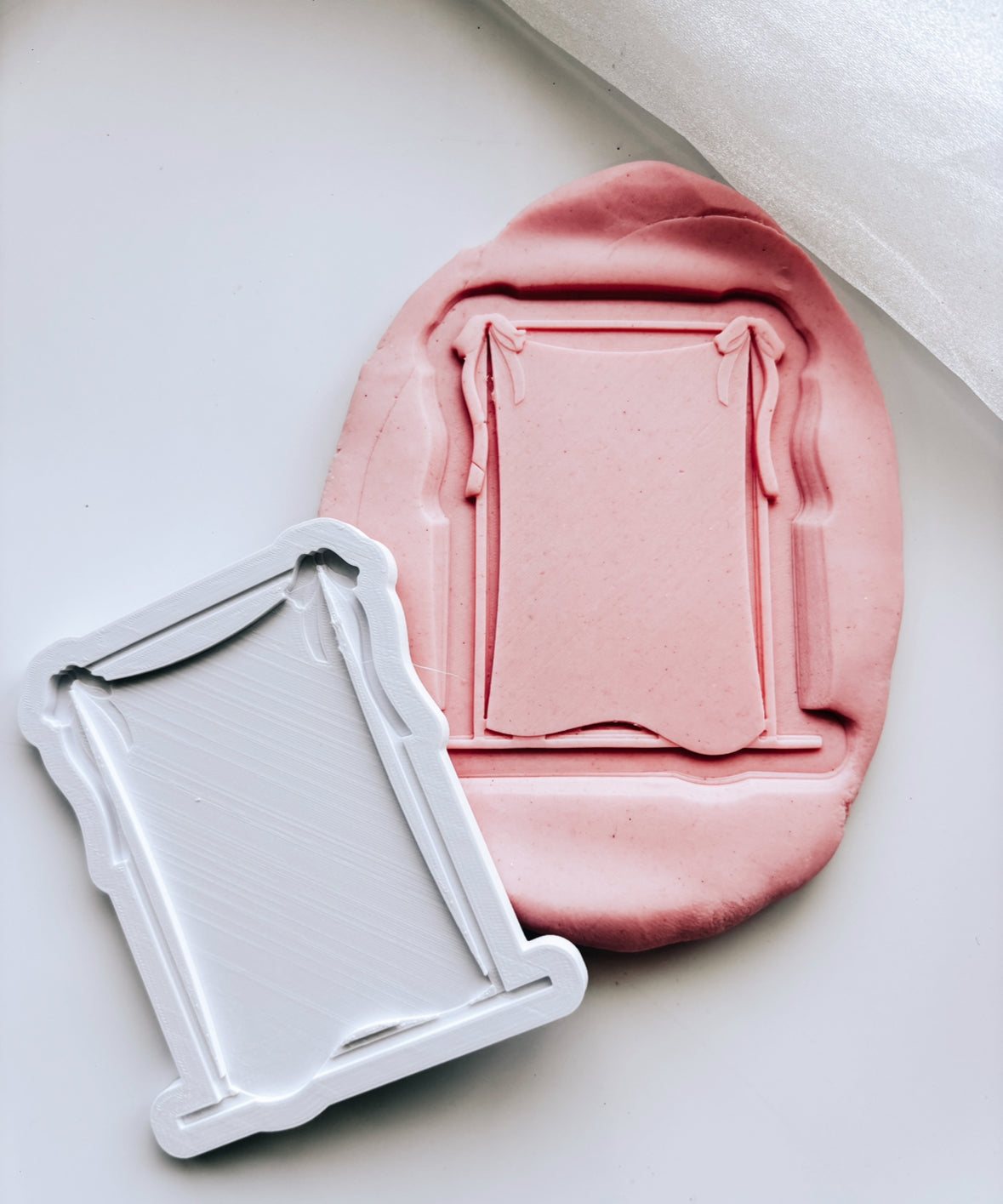 Blank draped material frame with bow on rectangle based stamp and cutter