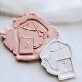 Long sleeved tied baby onesie with sonogram photo stamp and cutter