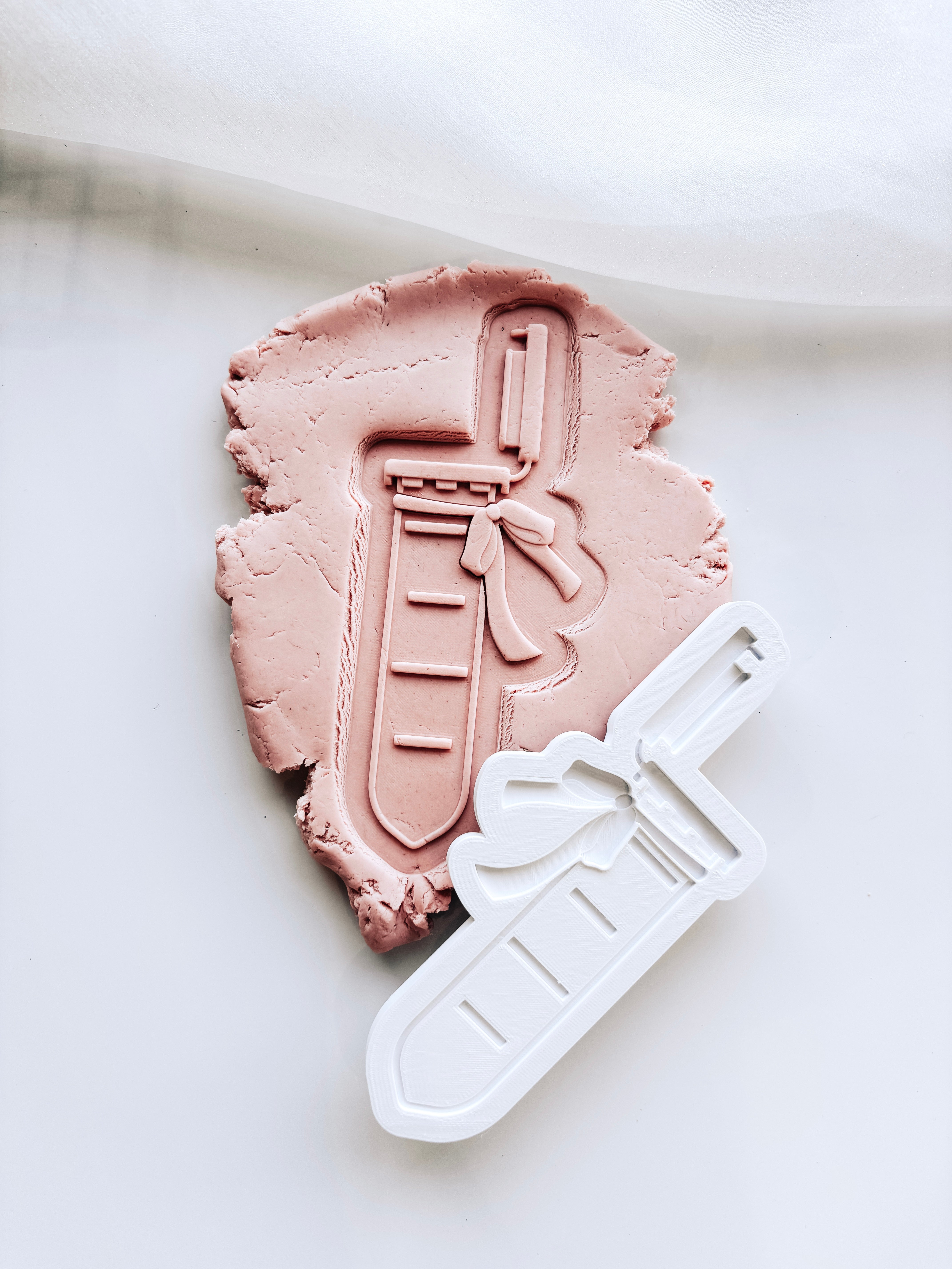 Test tube with bow stamp and cutter