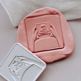 Hands holding baby scan photo stamp and cutter