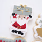 Santa holding present stamp and cutter