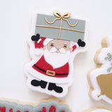 Santa holding present stamp and cutter