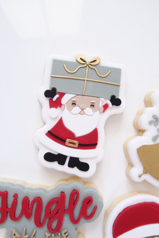 Santa holding present stamp and cutter