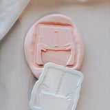 Hands holding book stamp and cutter