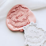 Bow covered cake with “one” stamp and cutter