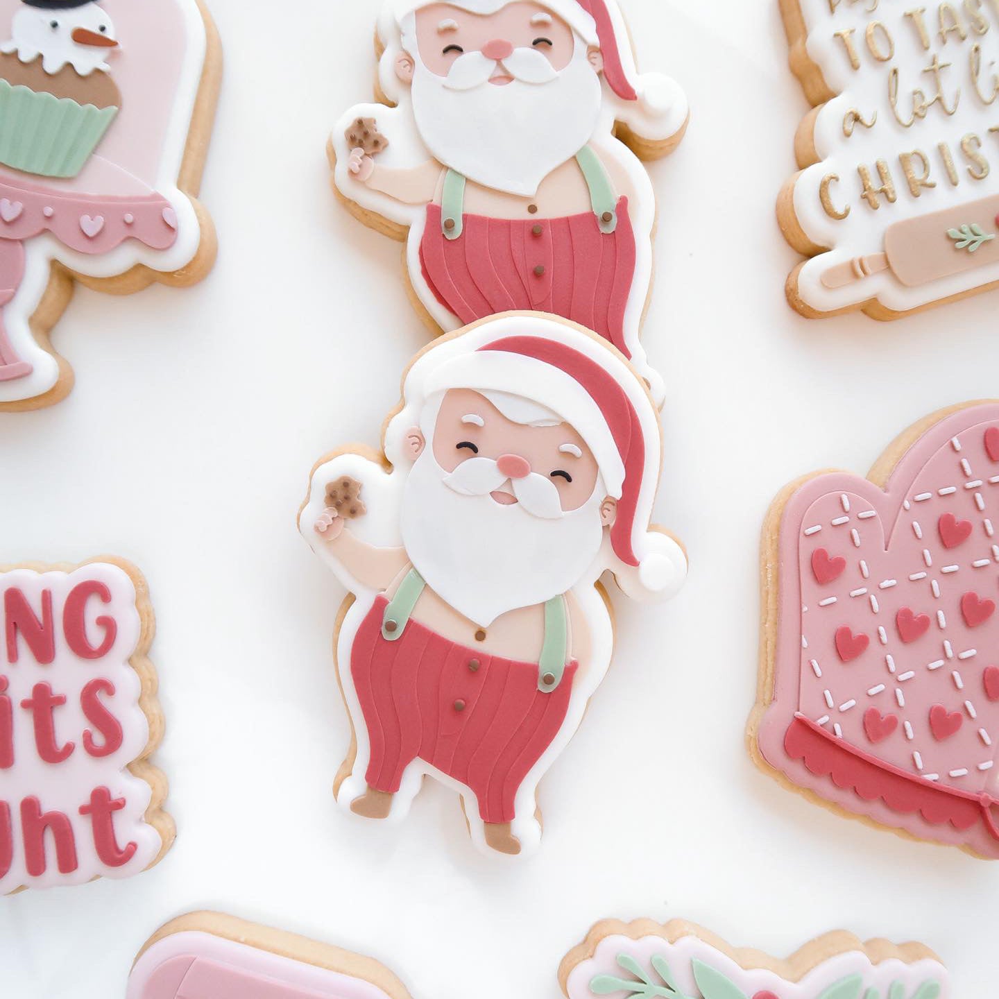 Santa Claus holding a cookie debosser and cutter