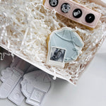 Long sleeved tied baby onesie with sonogram photo stamp and cutter