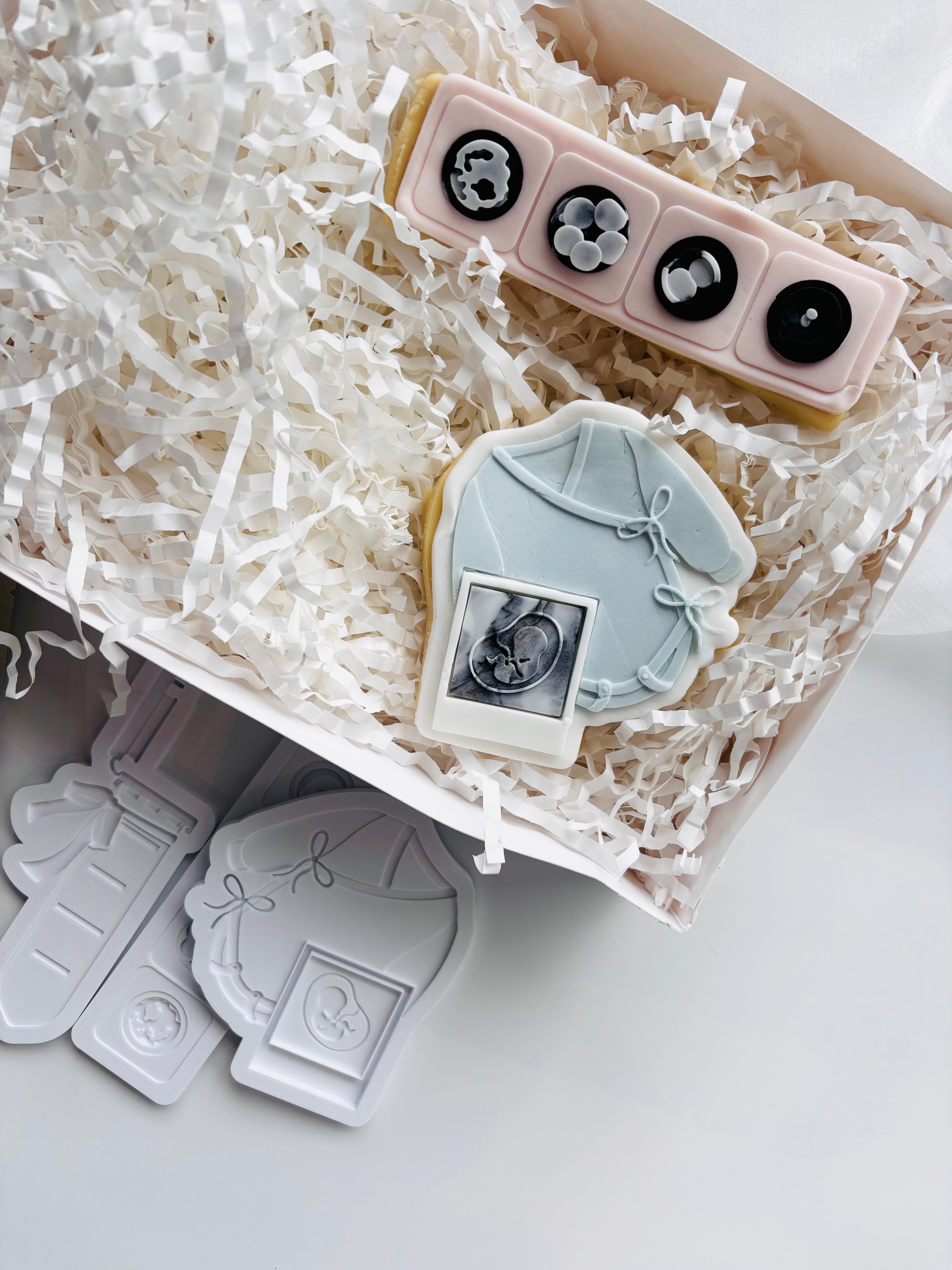 Long sleeved tied baby onesie with sonogram photo stamp and cutter