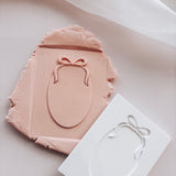 Oval with bow stamp and cutter