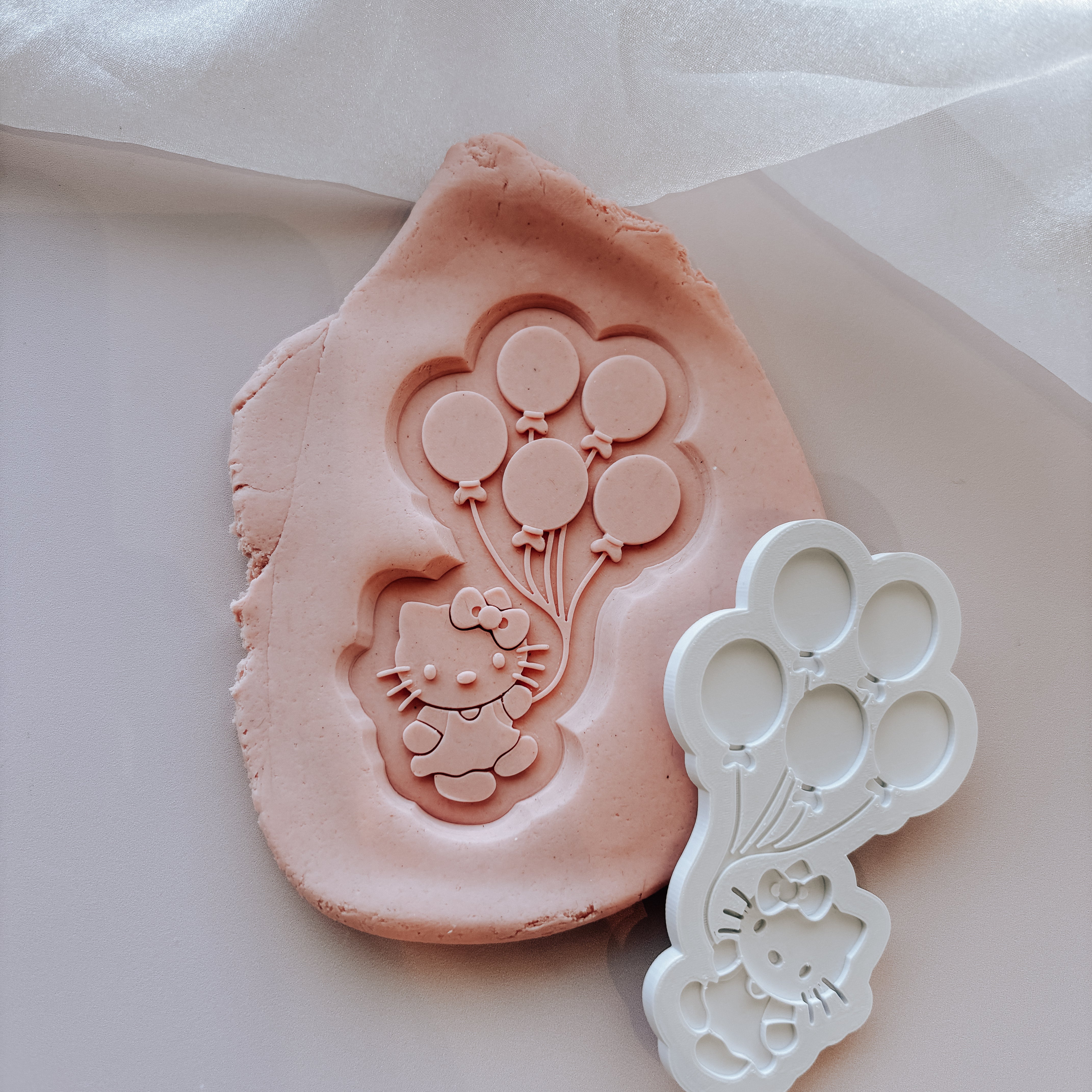 Hello Kitty holding a bunch of balloons stamp and cutter