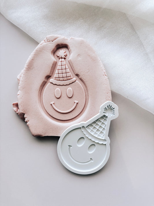 Smiley face with party hat stamp and cutter